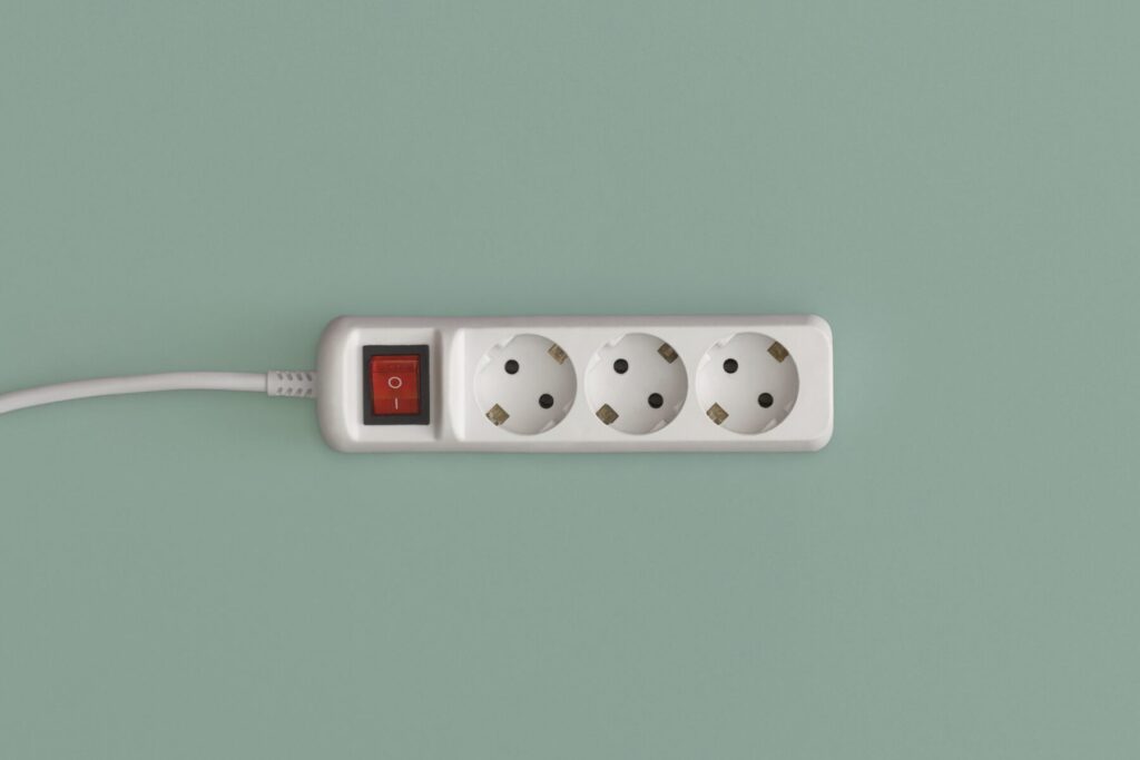 Wenn wir elektrisch aufgeladen sind, bekommen wir einen Schlag bei Kontakt mit Elektrogeräten wie der abgebildeten Steckdosenleiste oder bei Berührung mit anderen Menschen.